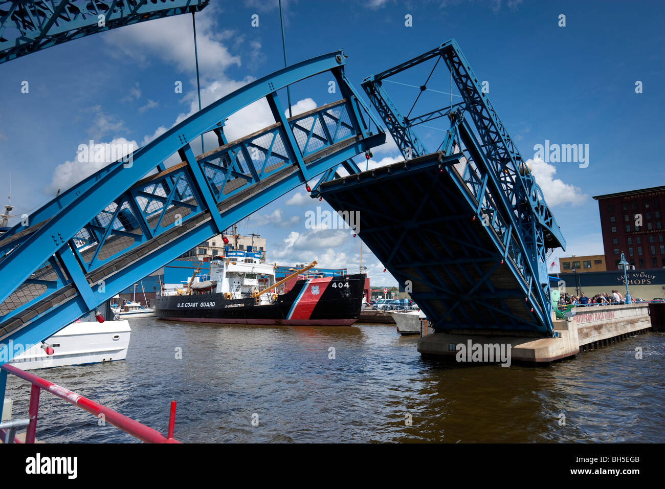 Bascule rising bridge in upright position, with US coastguard ship in background, Duluth, Minnesota, USA. Stock Photo