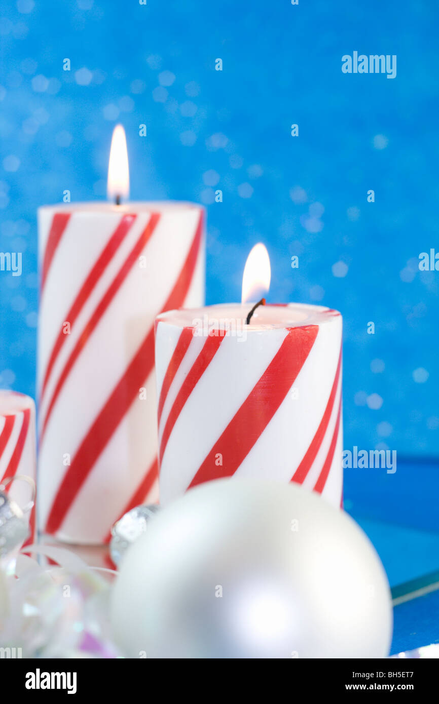 red striped Christmas candle with pearl white ornament Stock Photo