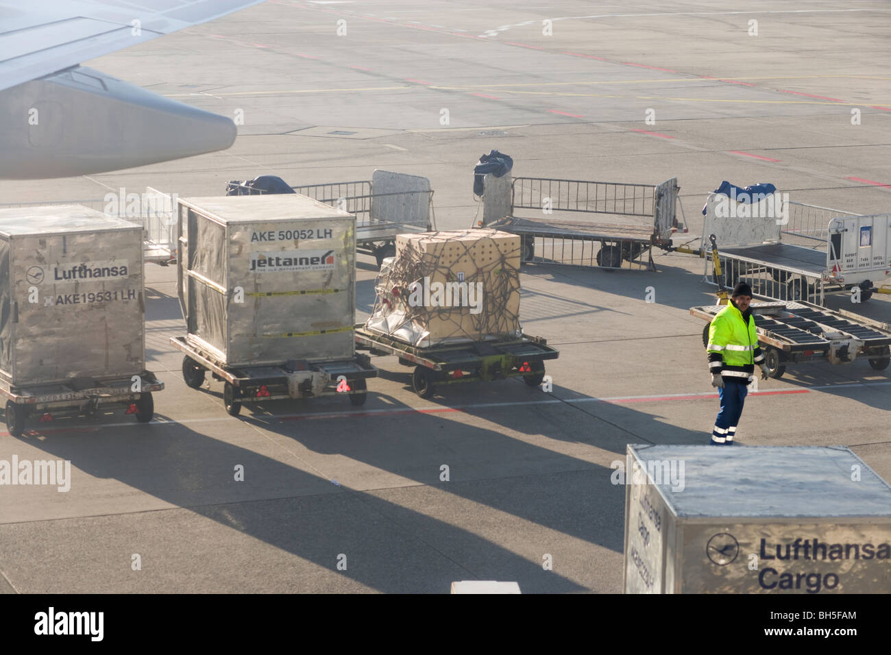 Aviation. Ground crew at Frankfurt Airport FRA handling Lufthansa and Jettainer AKE LD3 ULD cargo containers and pallets. Stock Photo