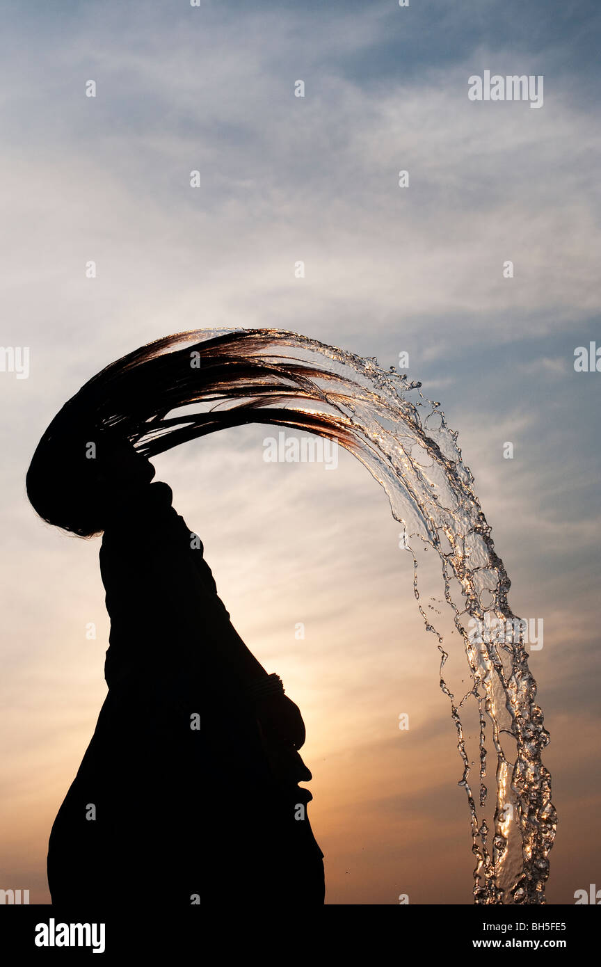 Indian girl throwing her wet hair back causing water spray silhouette. Andhra Pradesh, India Stock Photo - Alamy Indian girl throwing her wet hair back causing water spray silhouette. Andhra Pradesh, India Stock Photo - Alamy
