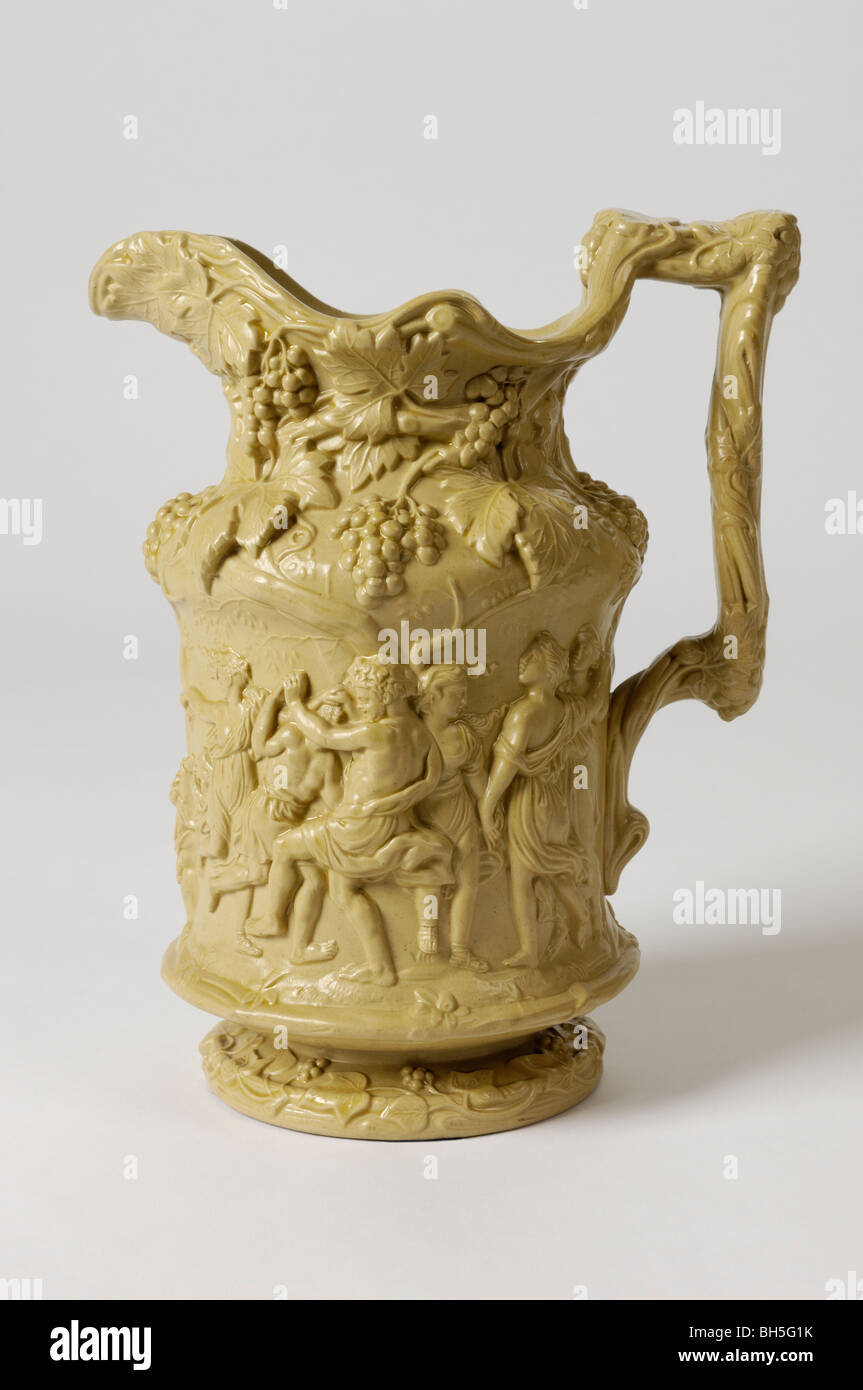 An antique 19th C. English stoneware relief moulded jug with  Bacchanalian ornament. Figures: infant Bacchus, old Silenus etc. Stock Photo