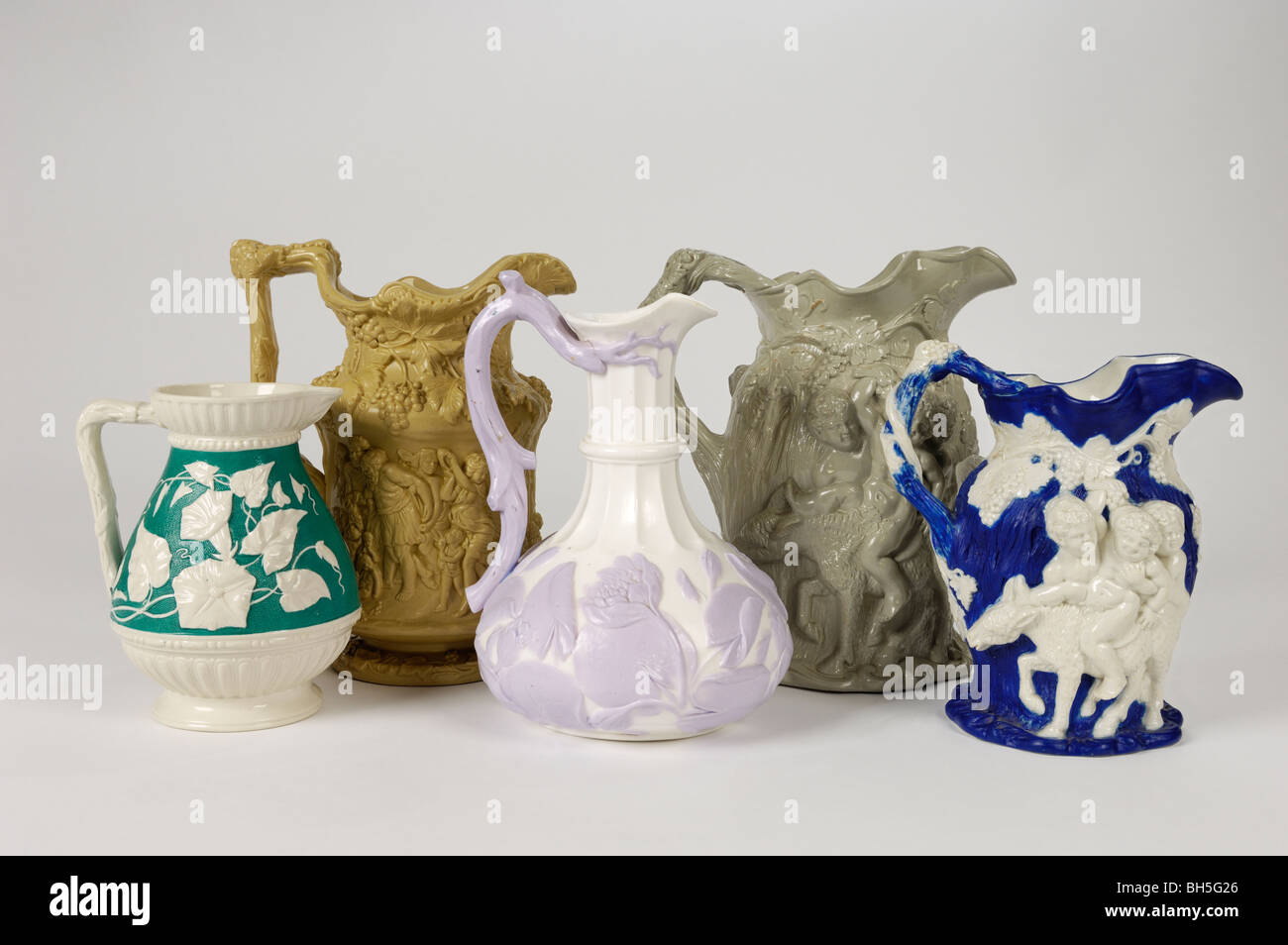 A group of antique 19th C. English stoneware relief moulded jugs including Bacchanalian and