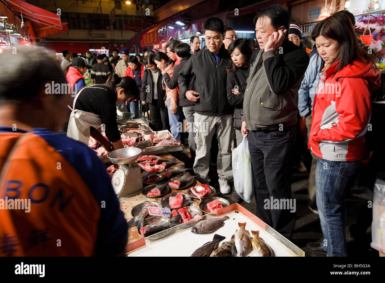 People shopping at Hong Kong's Bowrington Road wet market at night. Stock Photo