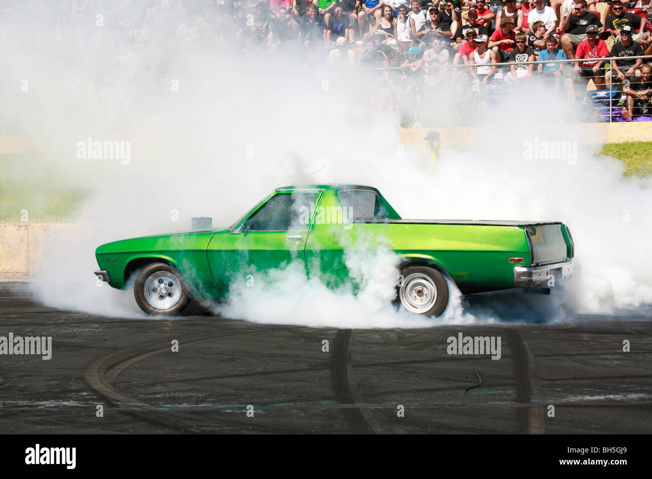 Iconic 1970s era Aussie Holden ute (pickup) performing a huge burnout Stock Photo