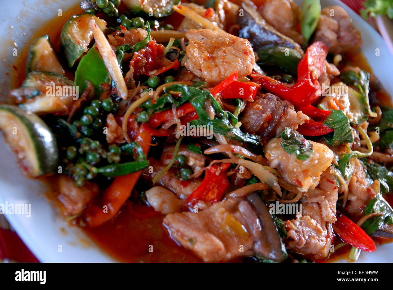 Spicy stir fry wild pork with young thai pepper and basil ( Moo Pad pa Kee  Mao or Moo pa pad Ped Stock Photo - Alamy