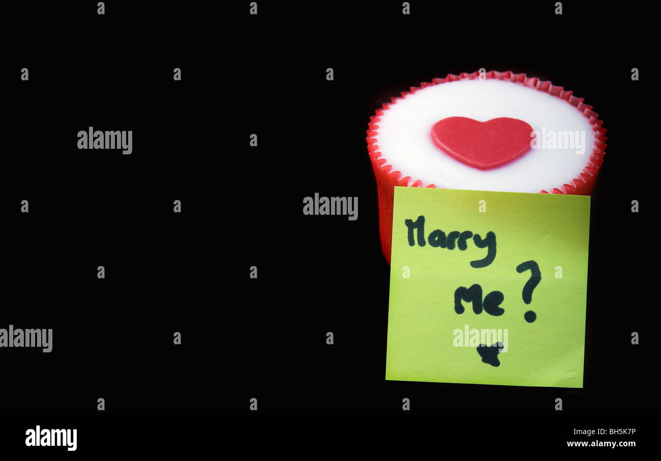 heart decorated cup-cake with a marry me sticker attached Stock Photo