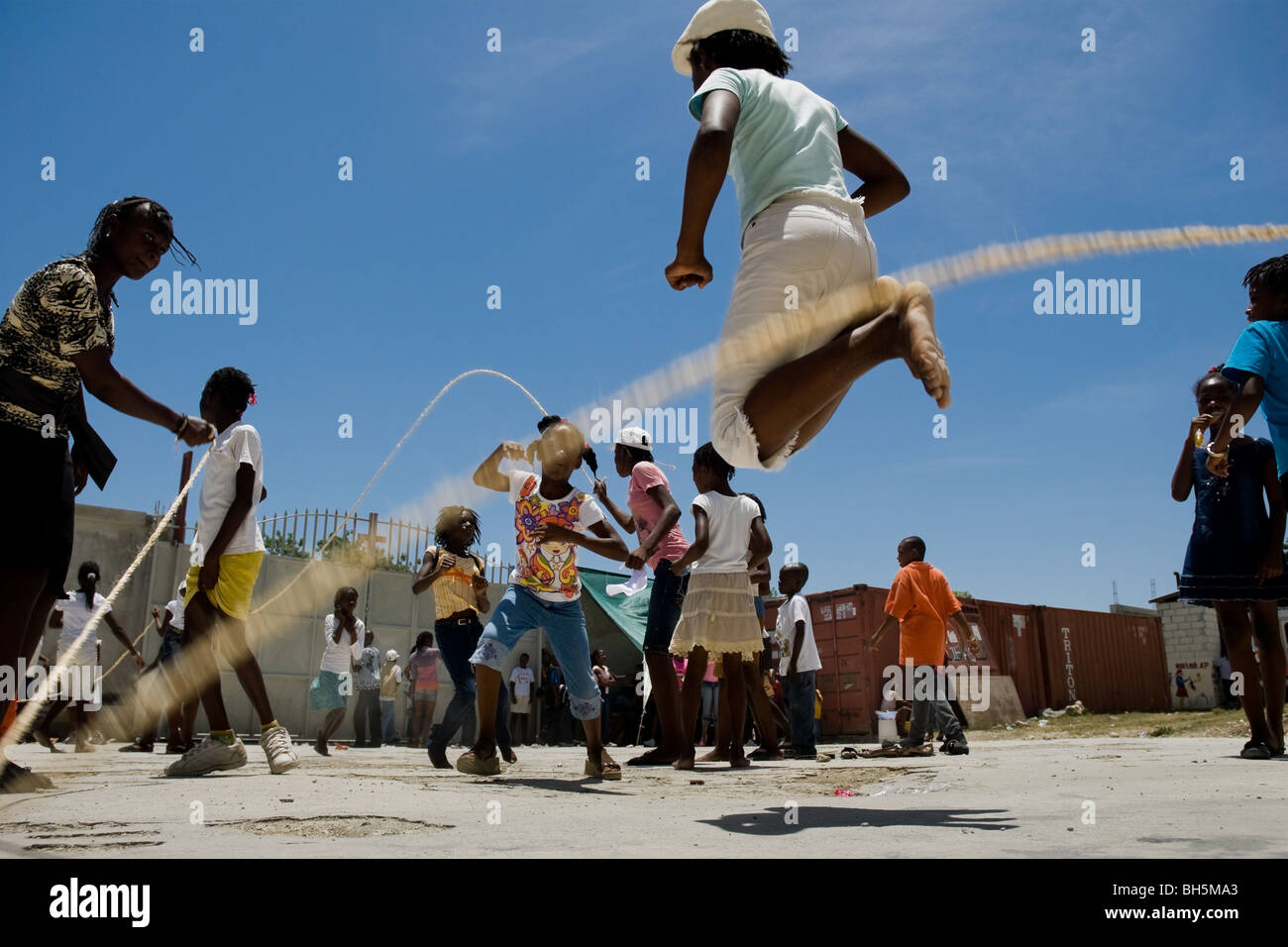 Haitian girls jumping rope in the backyard of Saint Claire, the education and feeding center in Port-au-Prince, Haiti. Stock Photo