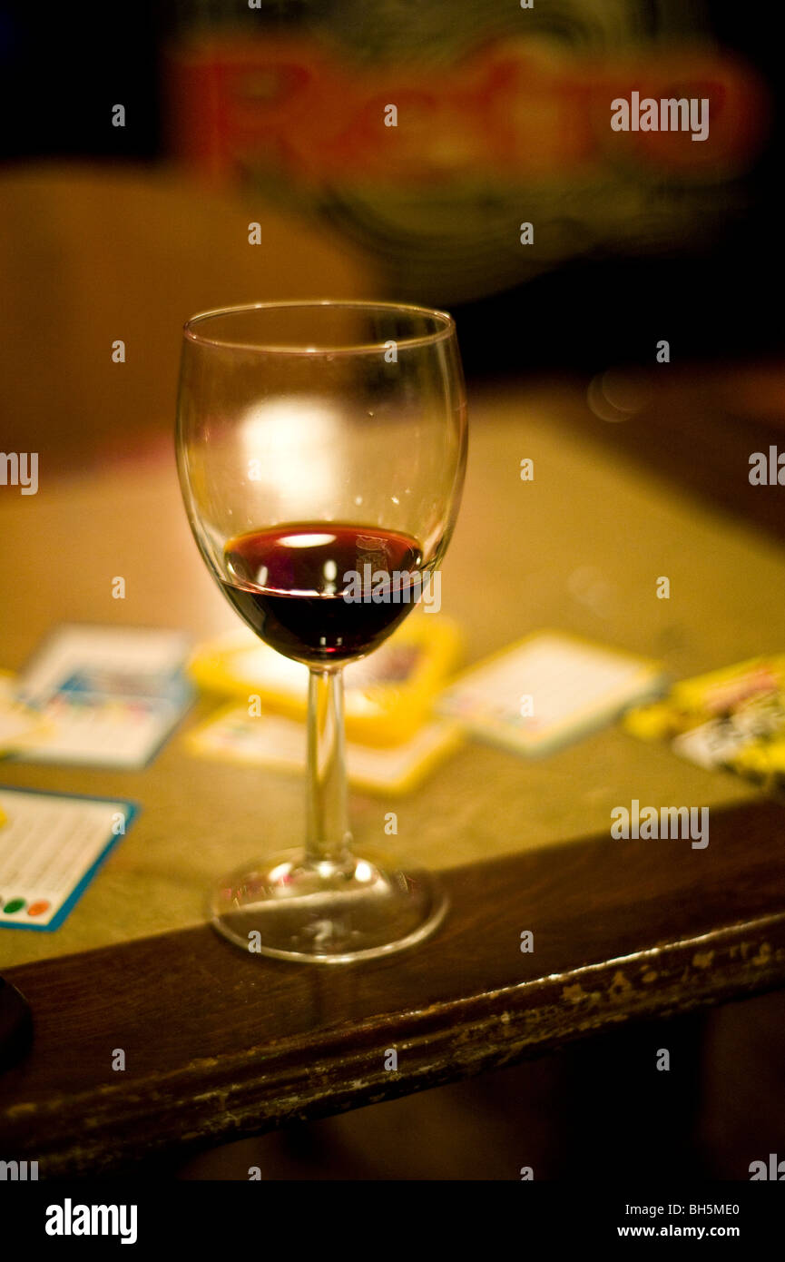 A glass of wine on a table in a bar Stock Photo