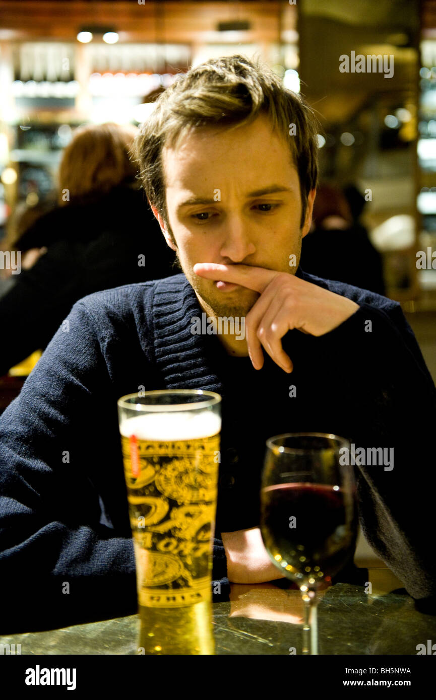 A young man drinking in a bar Stock Photo - Alamy