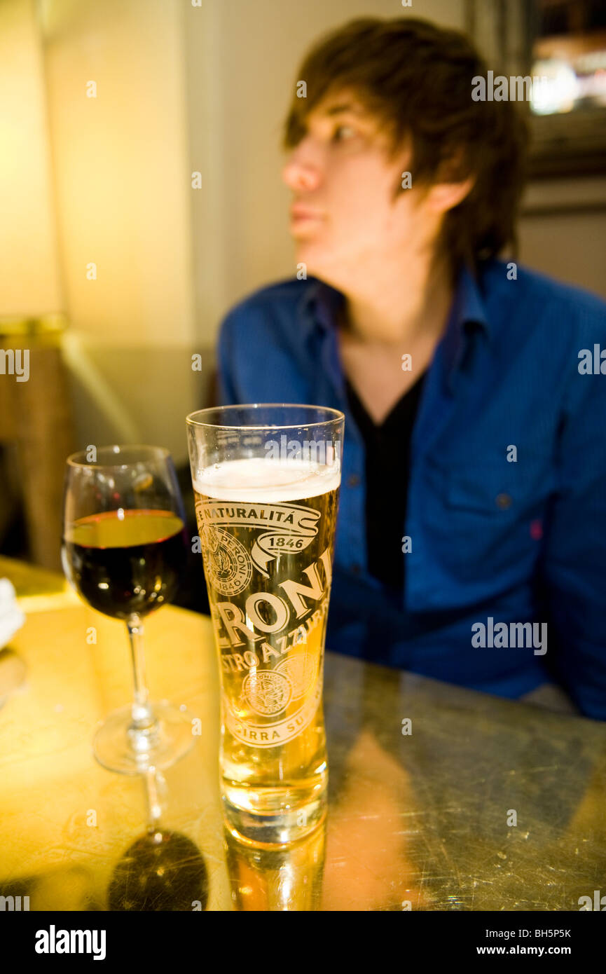 A young man drinking alcohol in a bar/pub Stock Photo