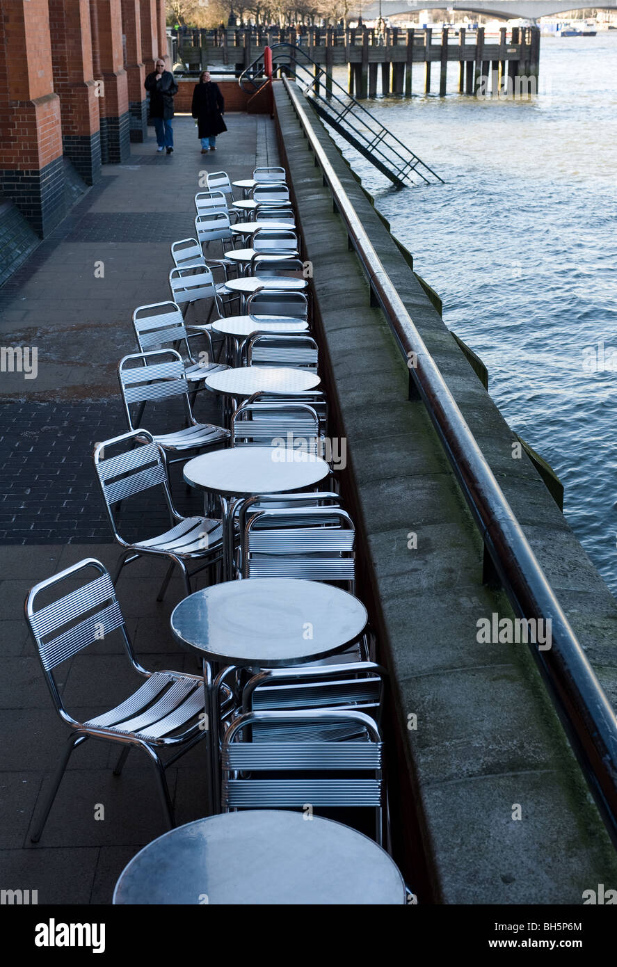 A row of empty tables and chairs on the South Bank in London.  Photo by Gordon Scammell Stock Photo