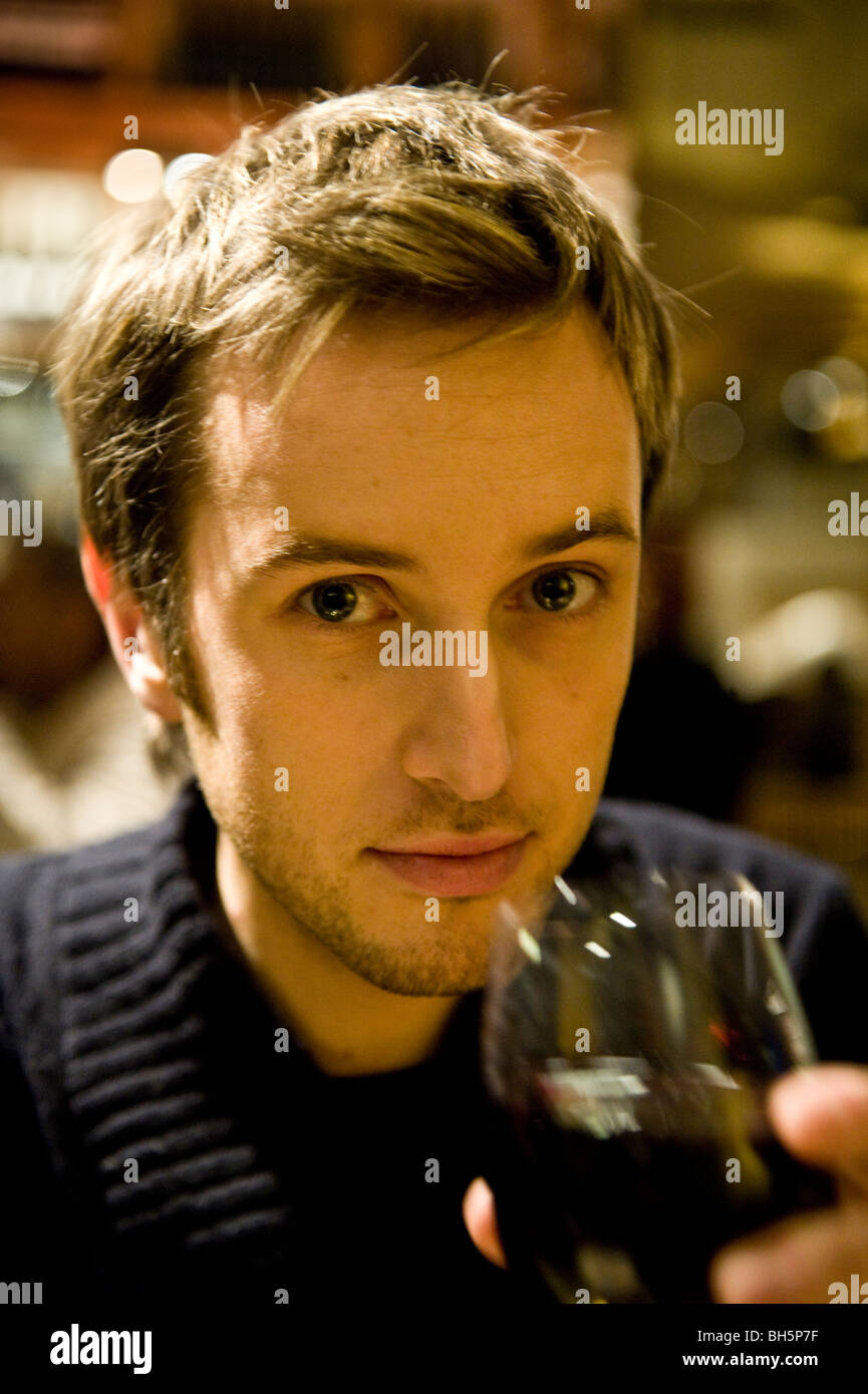 A young man drinking in a bar Stock Photo