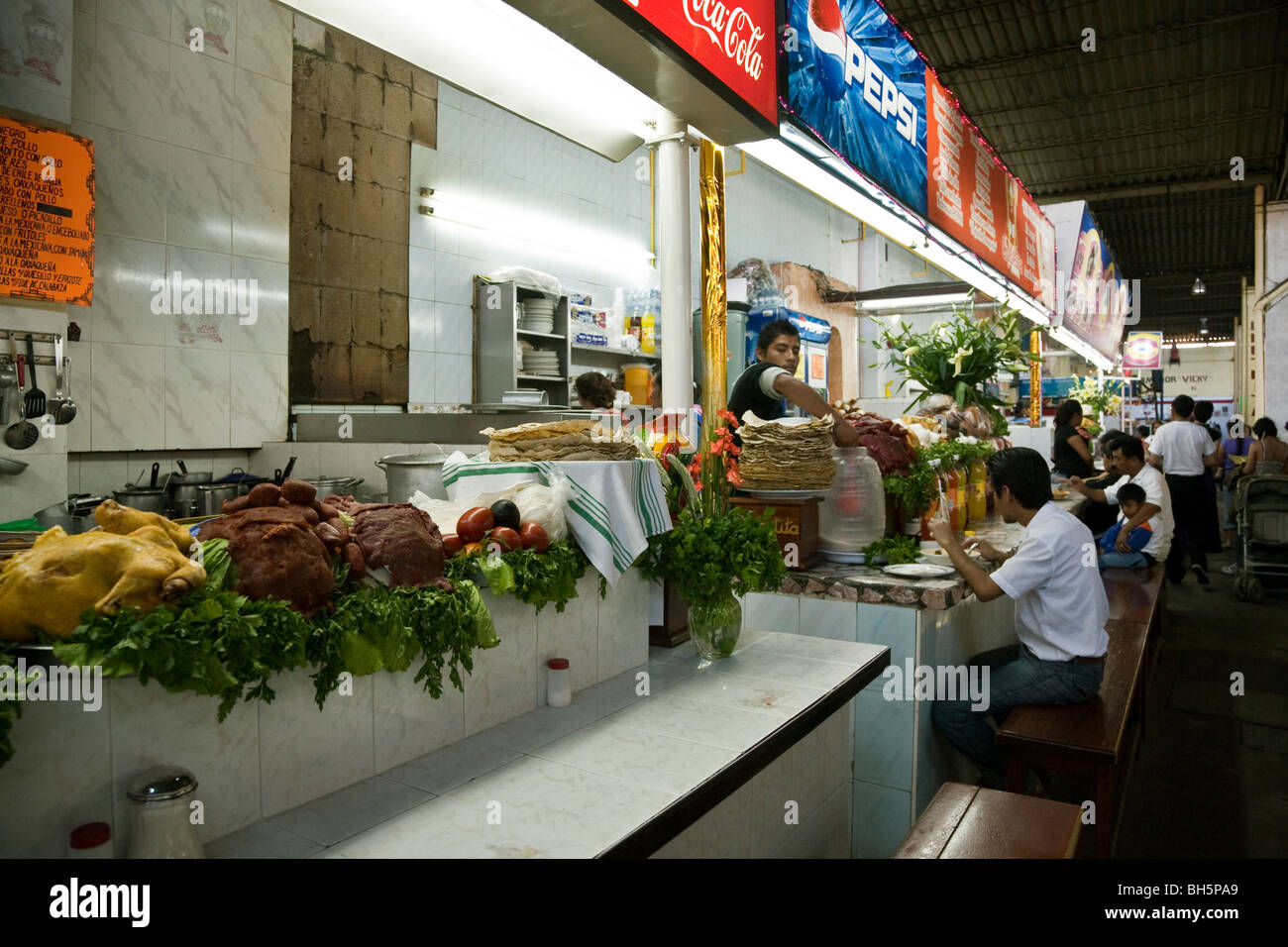 attractive long eating counter in November 20 Market with tempting display of fresh food ready to be cooked to order Oaxaca Stock Photo
