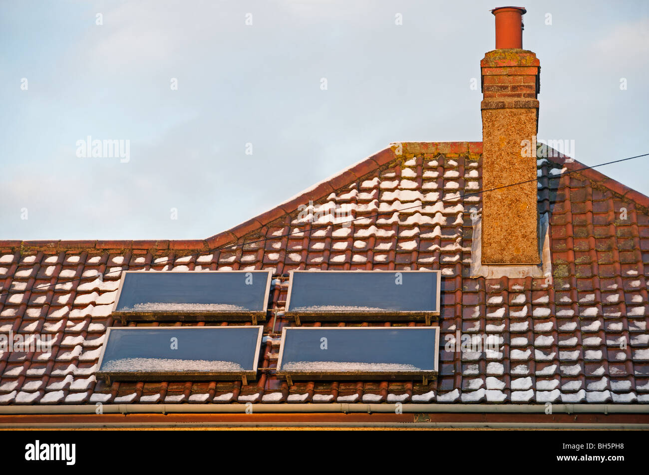 Solar panels fitted to the roof of a house in the UK. Stock Photo