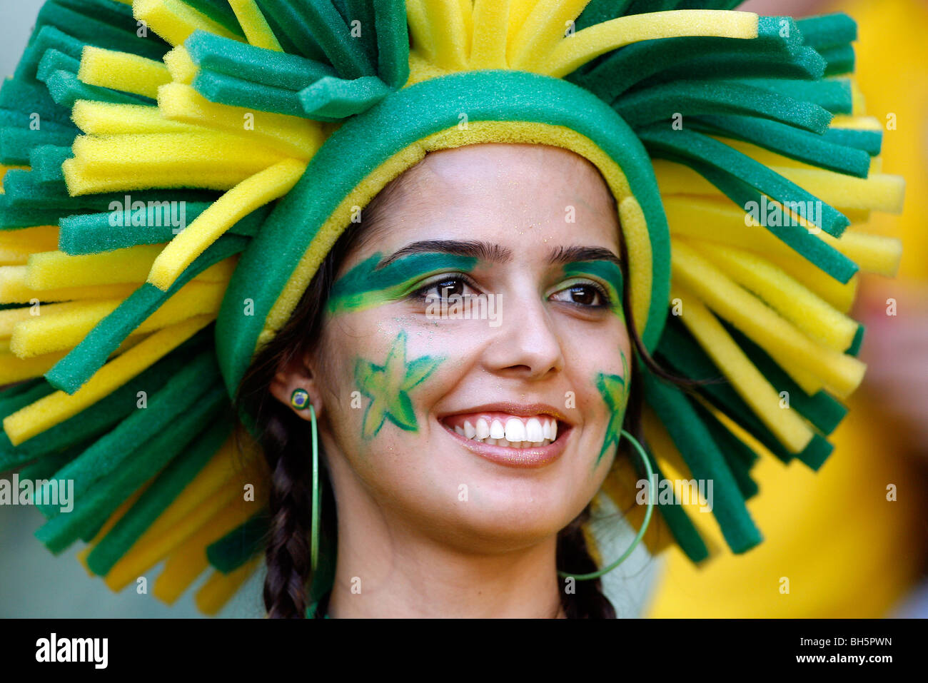 A pretty female Brazilian football fan with a painted face in the stands at the 2006 Football World Cup Finals Stock Photo