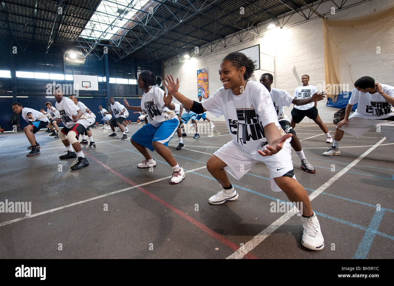 Teenagers warm up for a basketball game in a school gym Stock Photo Alamy