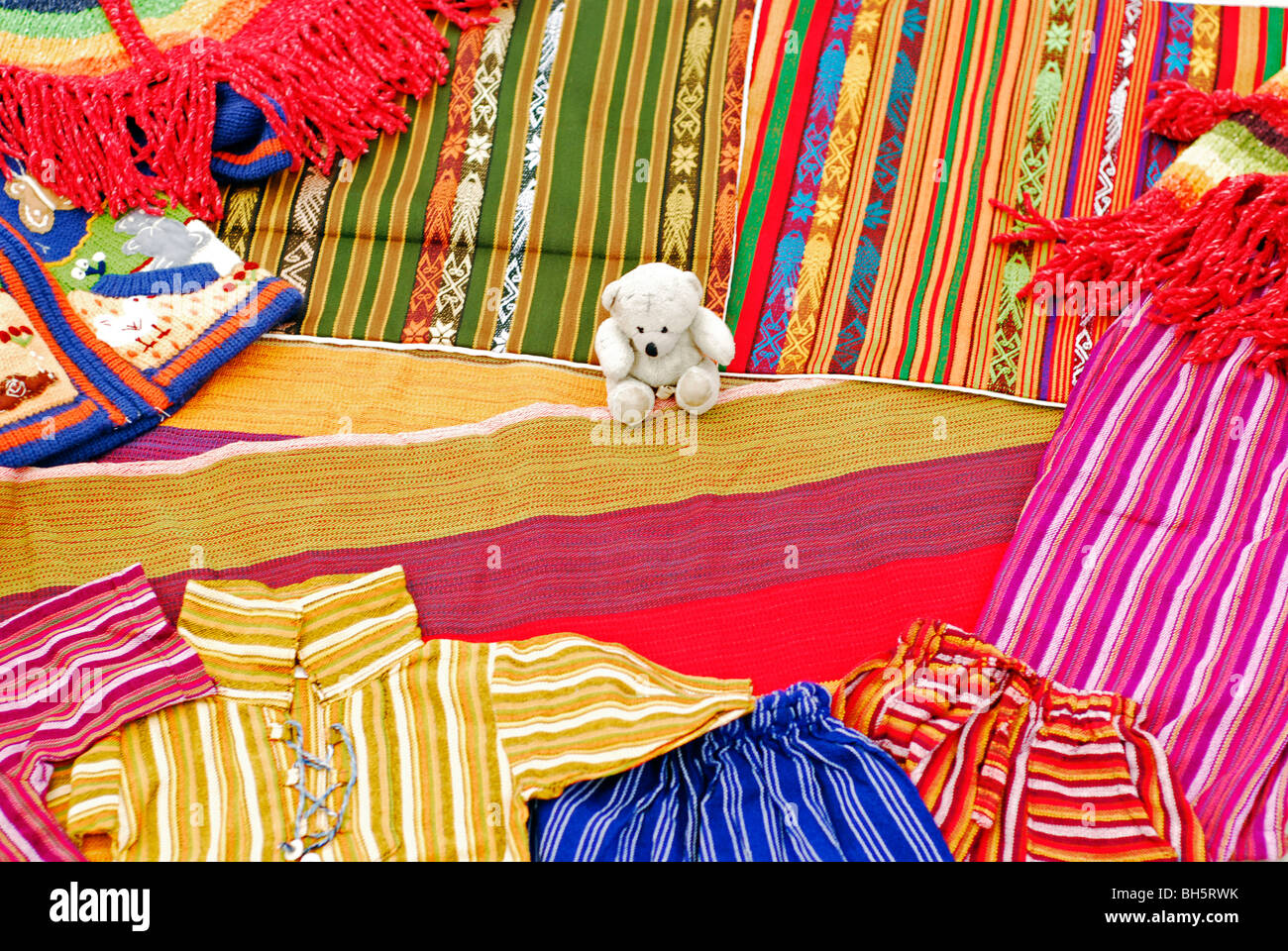 Ecuador, Otavalo, view of colorful textile materials (shirts, hammock