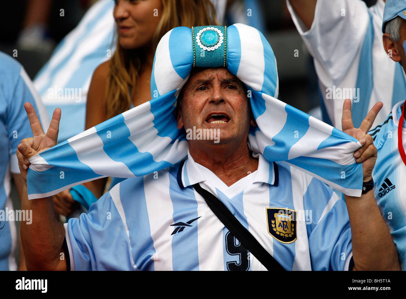 An Argentinan Football fan sings in the stands at the 2006 Football World Cup Stock Photo