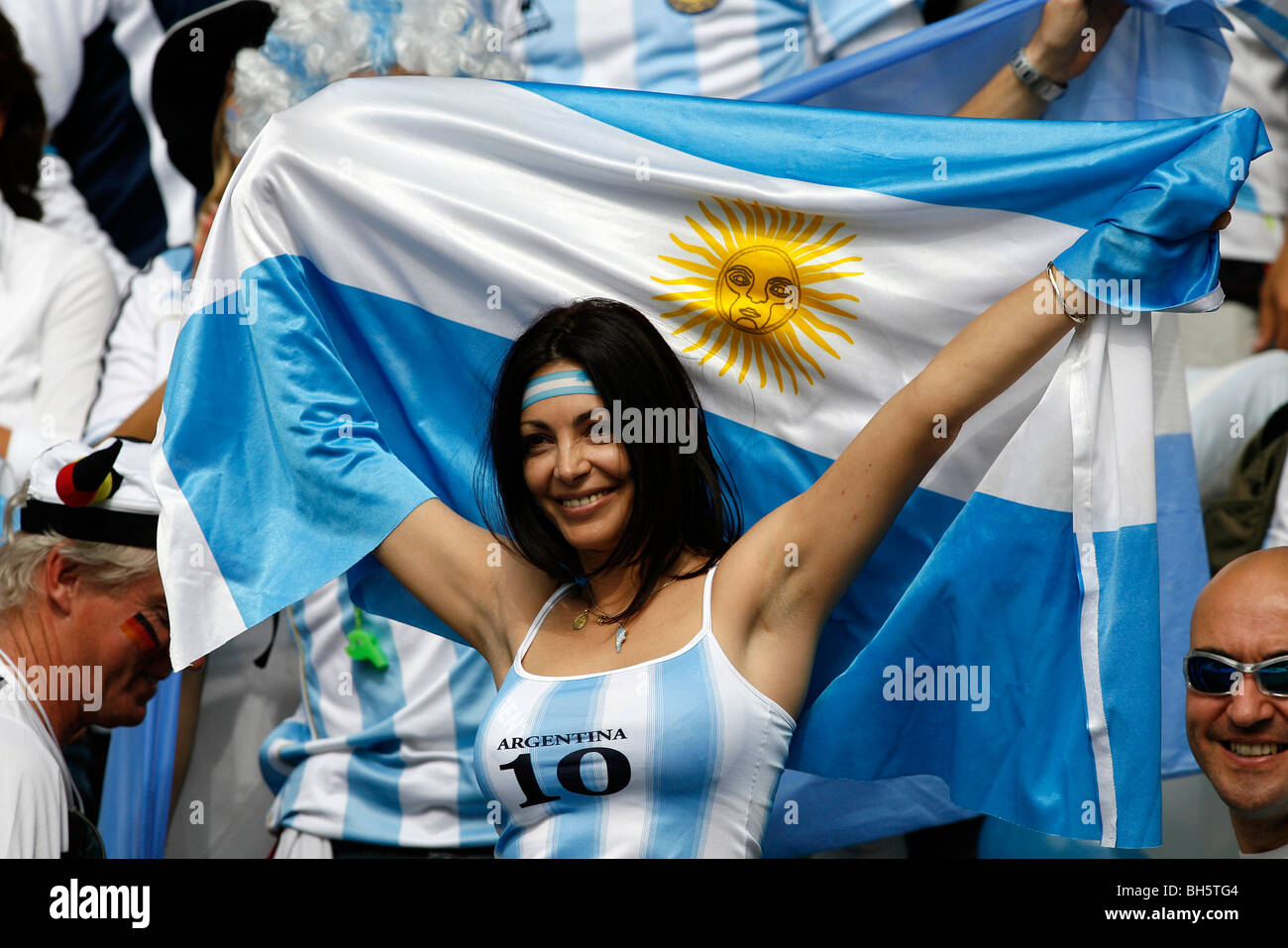 A female Argentinan Football fan holds up a flag in the stands at the 2006 Football World Cup Stock Photo