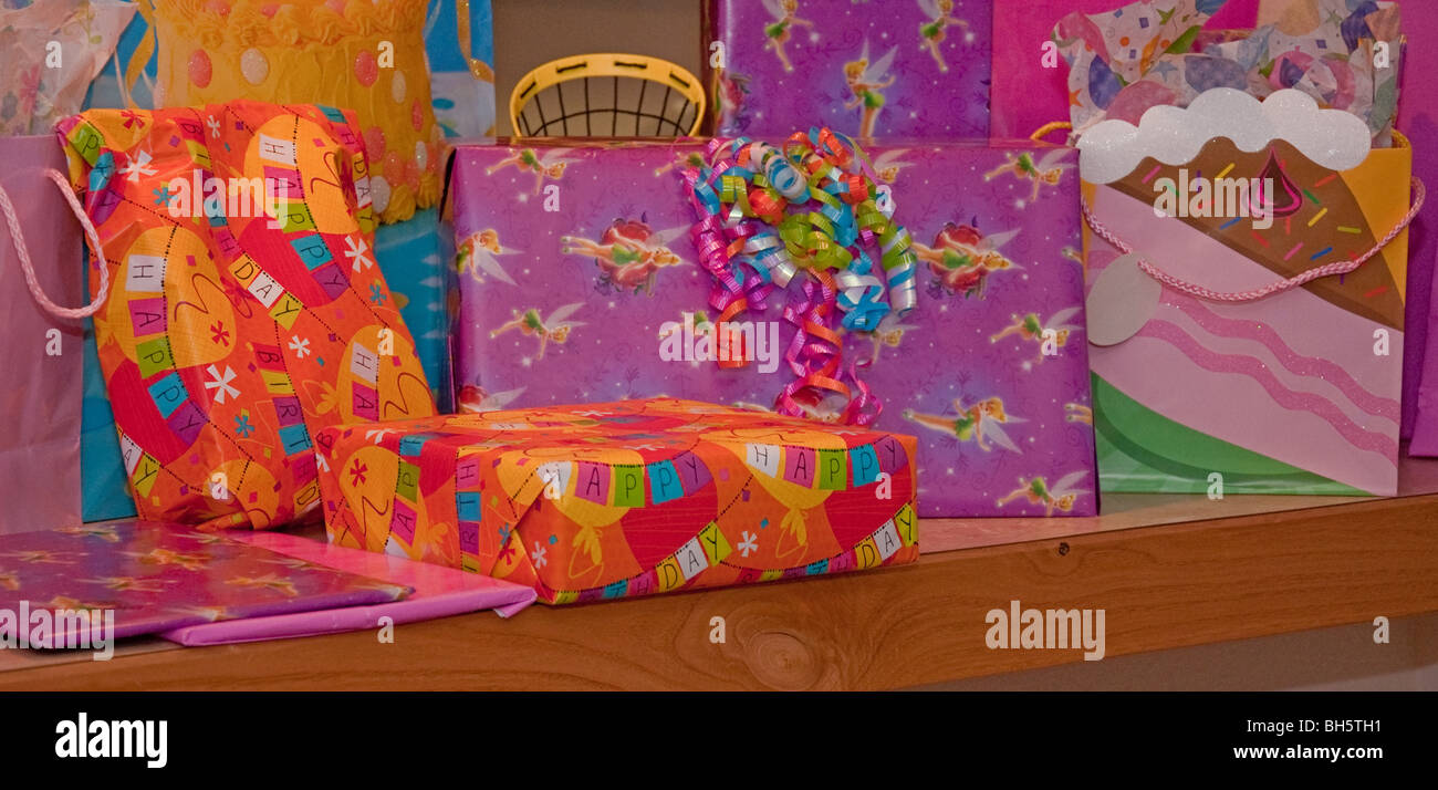 This photo shows a shelf full of a child's birthday presents, just waiting to be opened in a very colorful array. Stock Photo