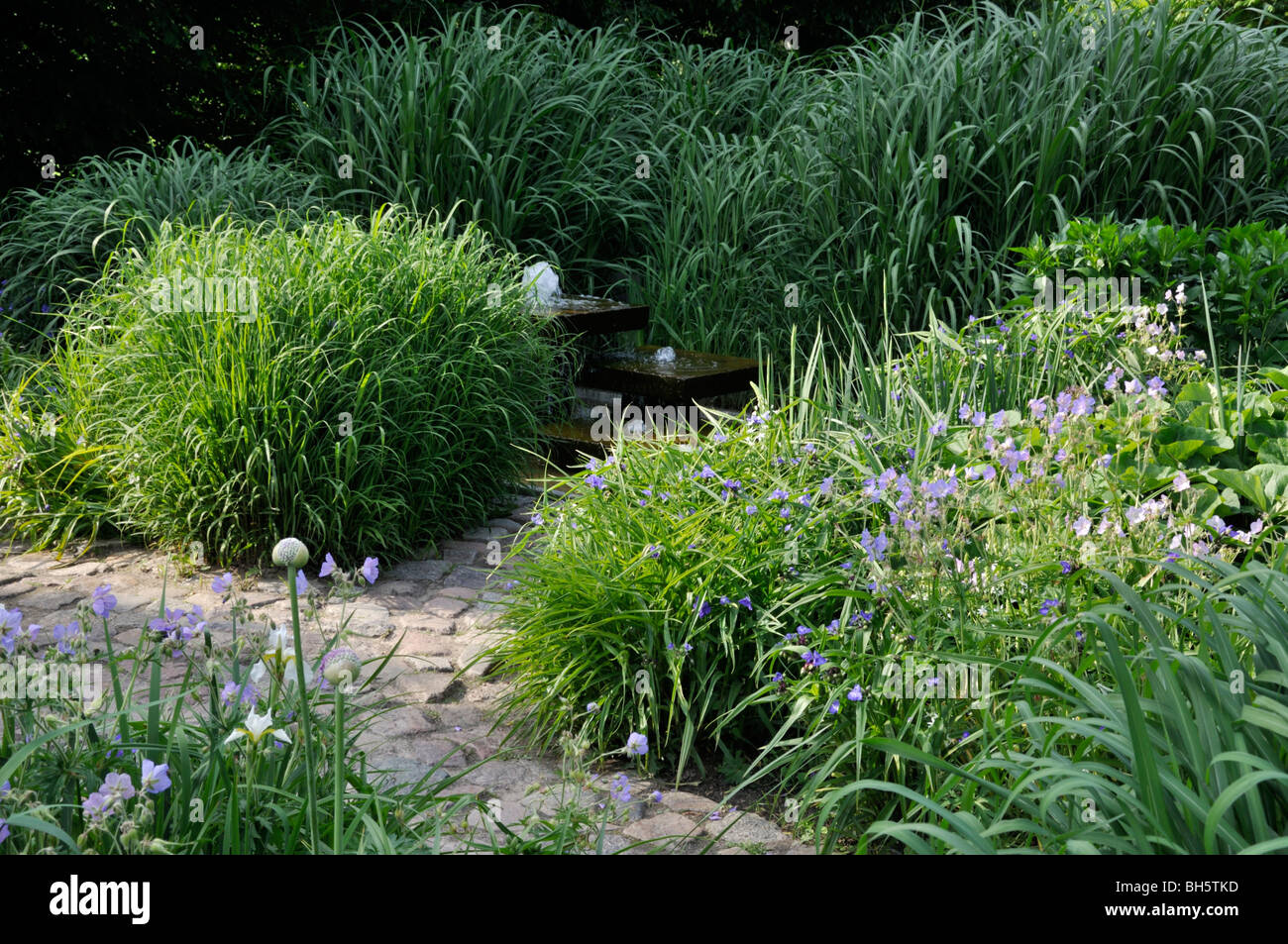 Perennial garden with fountain Stock Photo