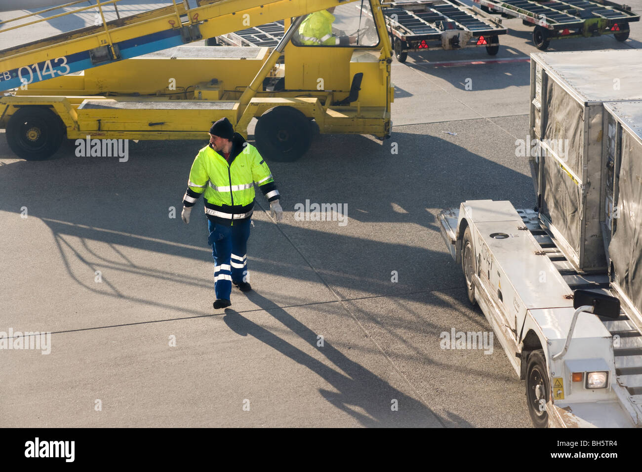 Aviation. Ground crew at Frankfurt International Airport FRA handling Lufthansa luggage baggage cargo containers. Stock Photo