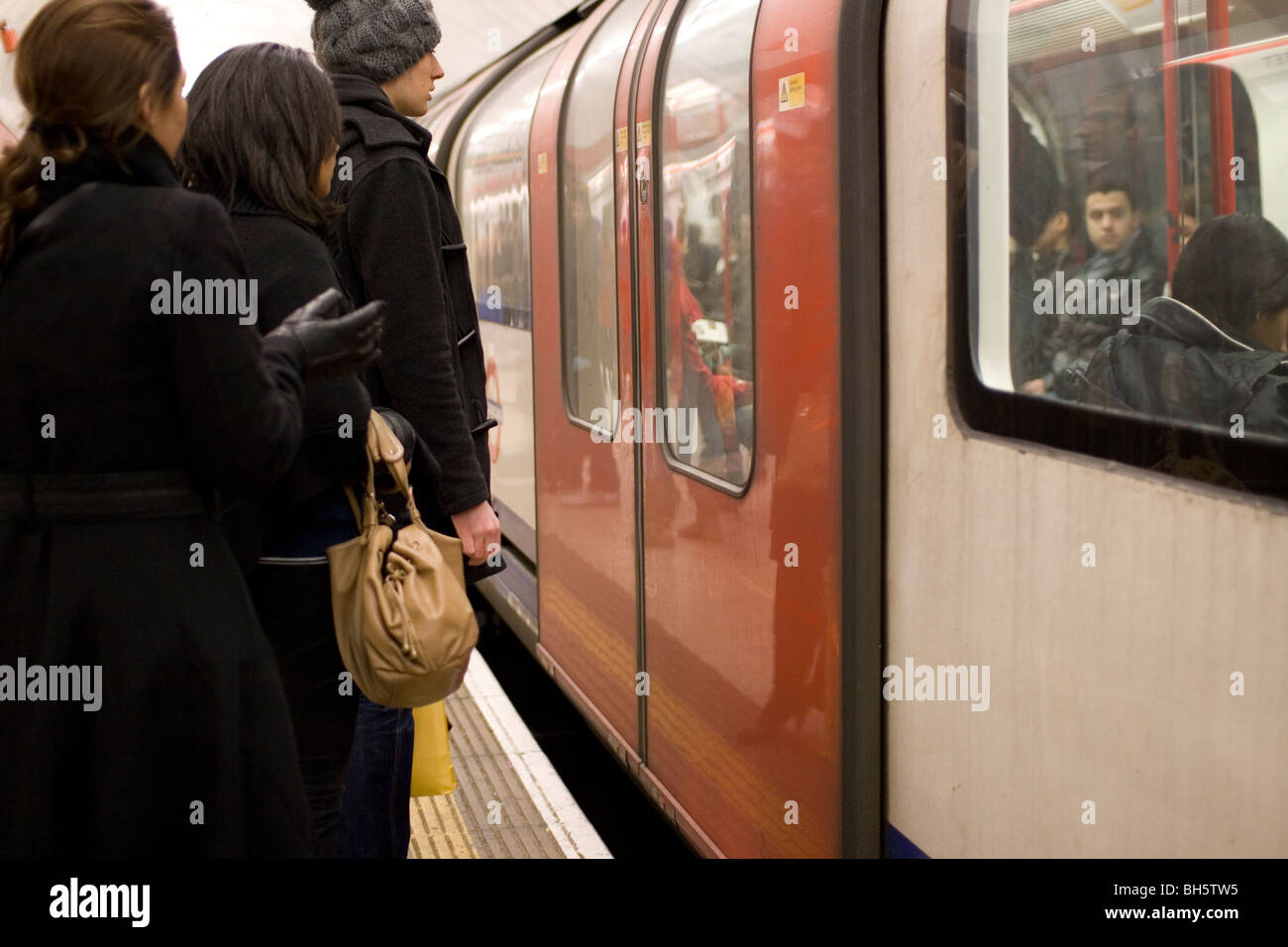 Waiting to board a train on the London Underground. Stock Photo