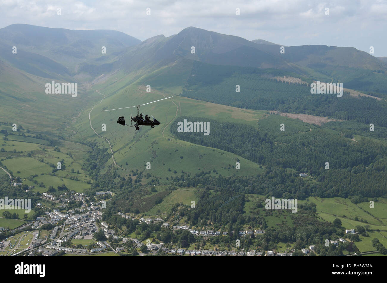autogyro being flown over Braithwaite in the Lake District Stock Photo