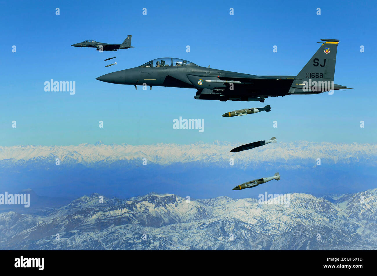 U.S. Air Force F-15E Strike Eagle aircraft drops 2,000-pound joint direct attack munitions. Stock Photo