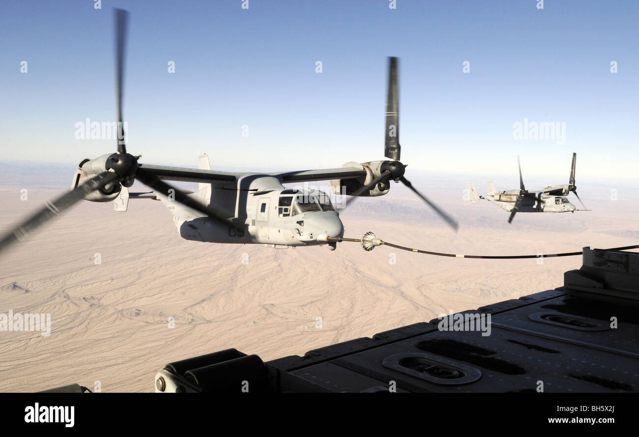 A MV-22 Osprey refuels midflight while another waits its turn. Stock Photo