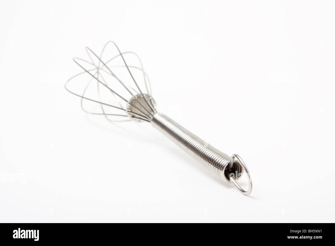 Stainless steel chef's whisk isolated against white background. Stock Photo