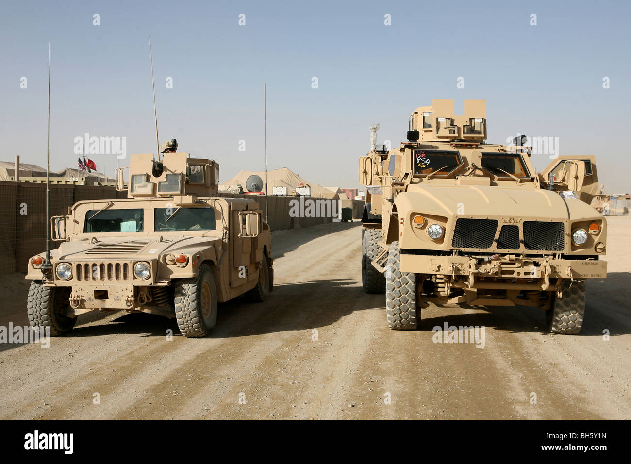 The Mine Resistant Ambush Protected All Terrain Vehicle and its predecessor, the humvee. Stock Photo