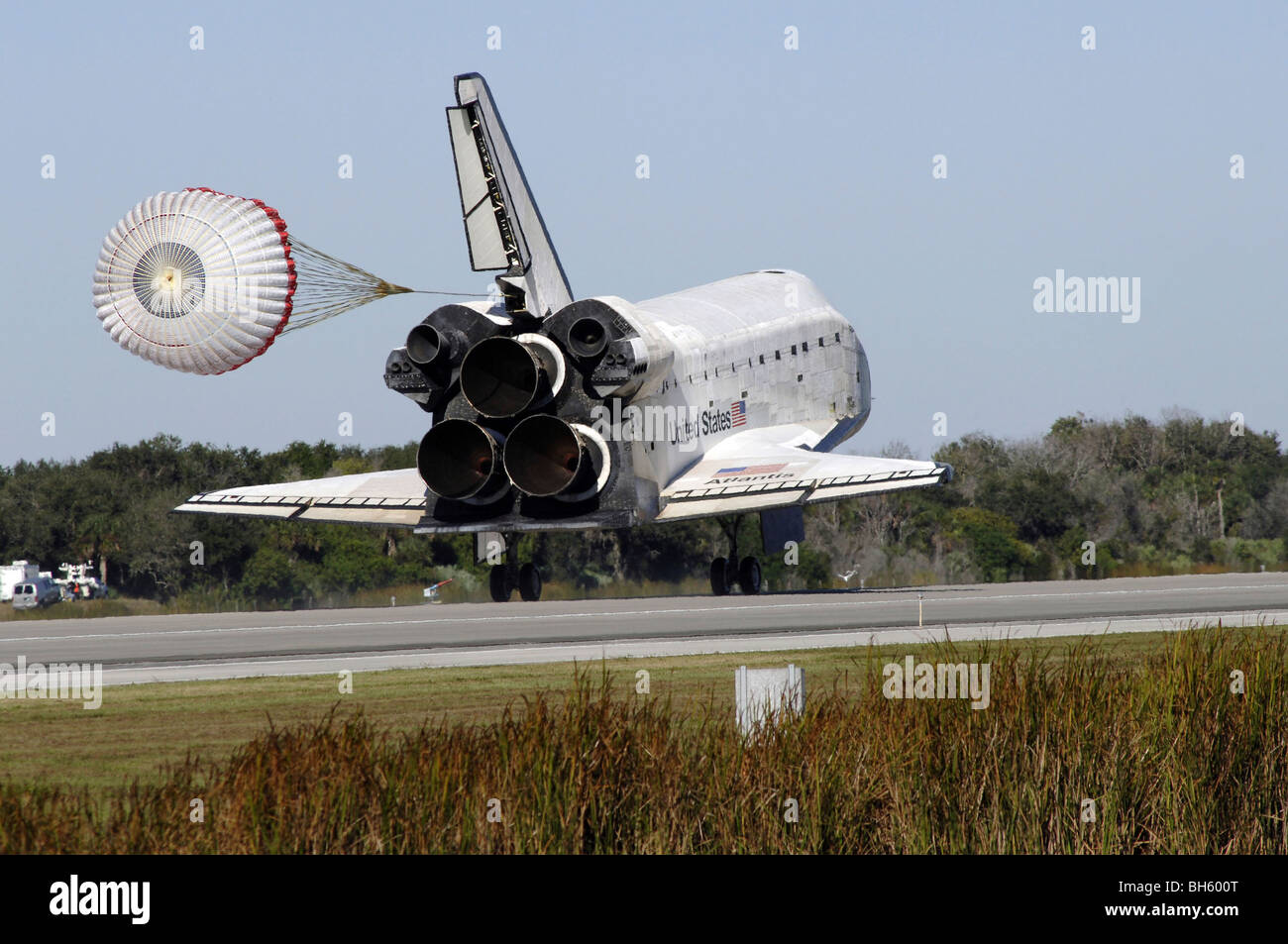 Space shuttle Atlantis unfurls its drag chute upon landing at Kennedy Space Center, Florida. Stock Photo