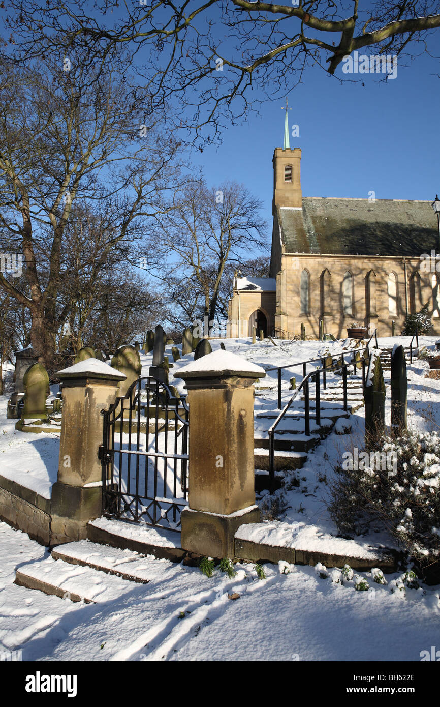 Holy Trinity church, Washington, seen past the church gate and cemetery in wintry conditions. Tyne and Wear, England, UK Stock Photo