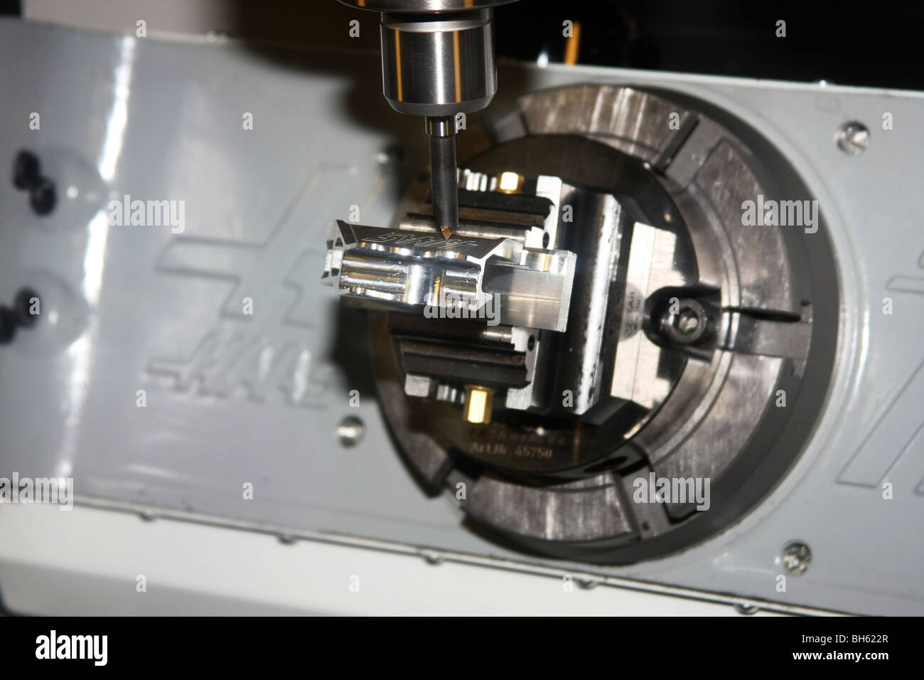 detail of milling tool on automatic computerised machine making part for motor vehicle. Stock Photo