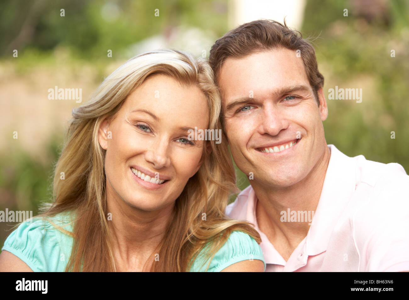 Young Couple Relaxing In Garden Stock Photo