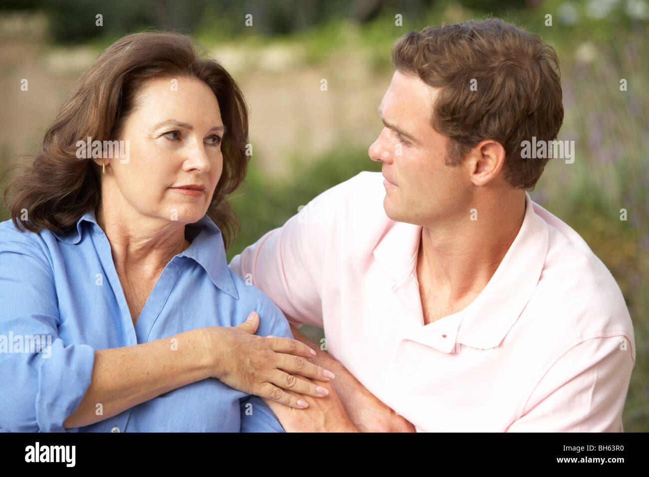 Senior Woman Being Comforted By Adult Son Stock Photo Alamy