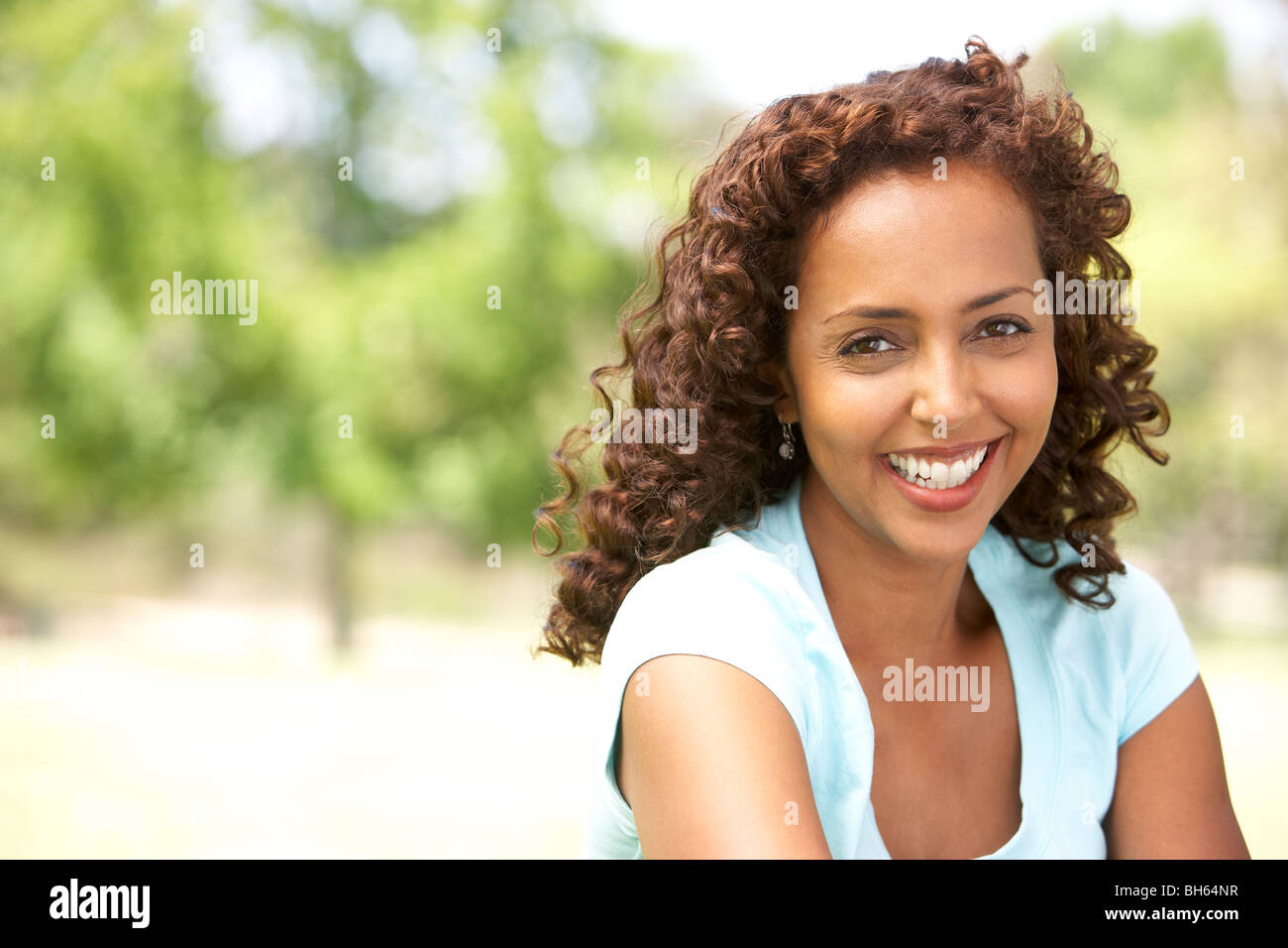 Portrait Of Young Woman In Park Stock Photo - Alamy