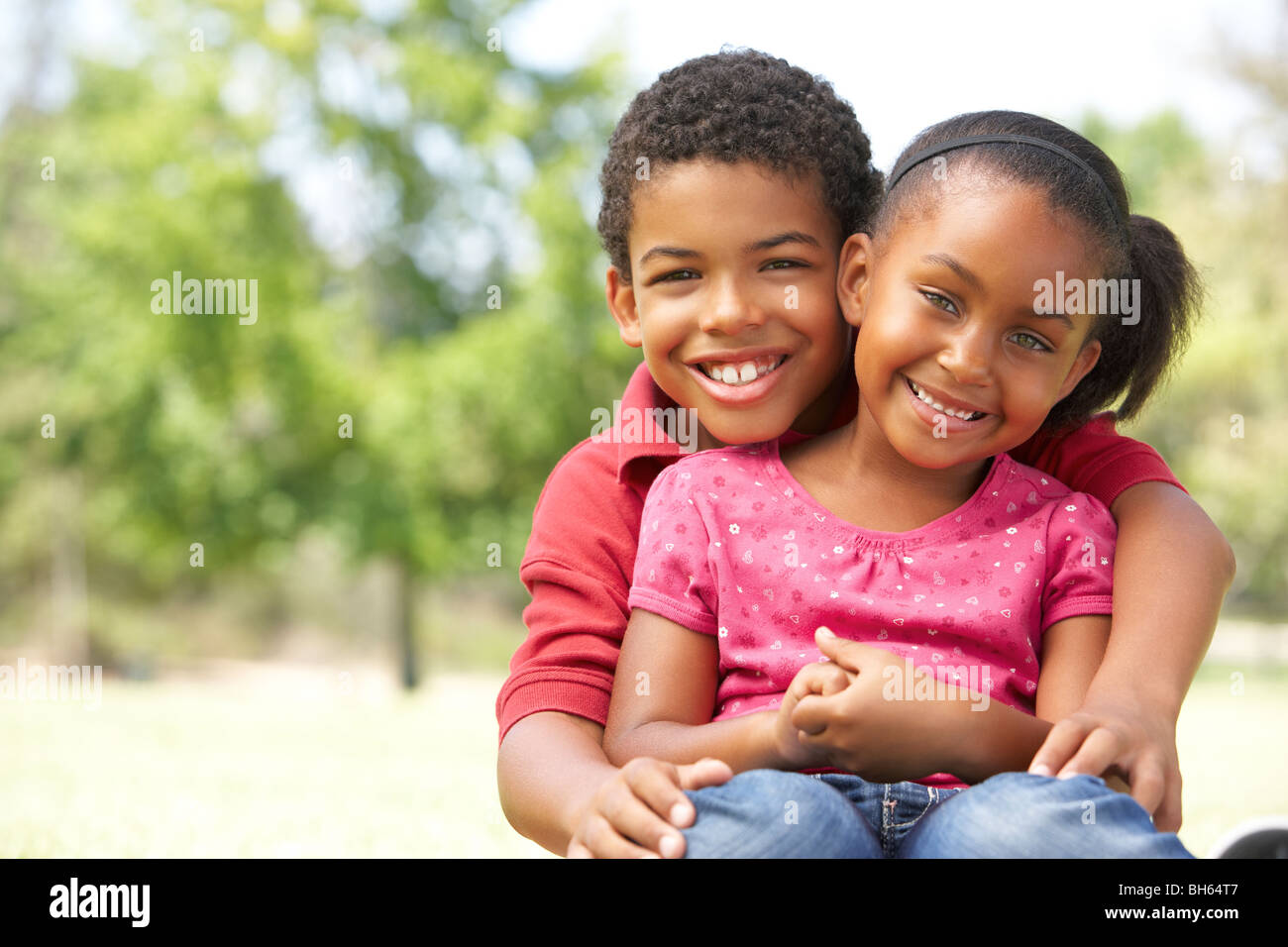 Portrait Of Brother And Sister In Park Stock Photo - Alamy