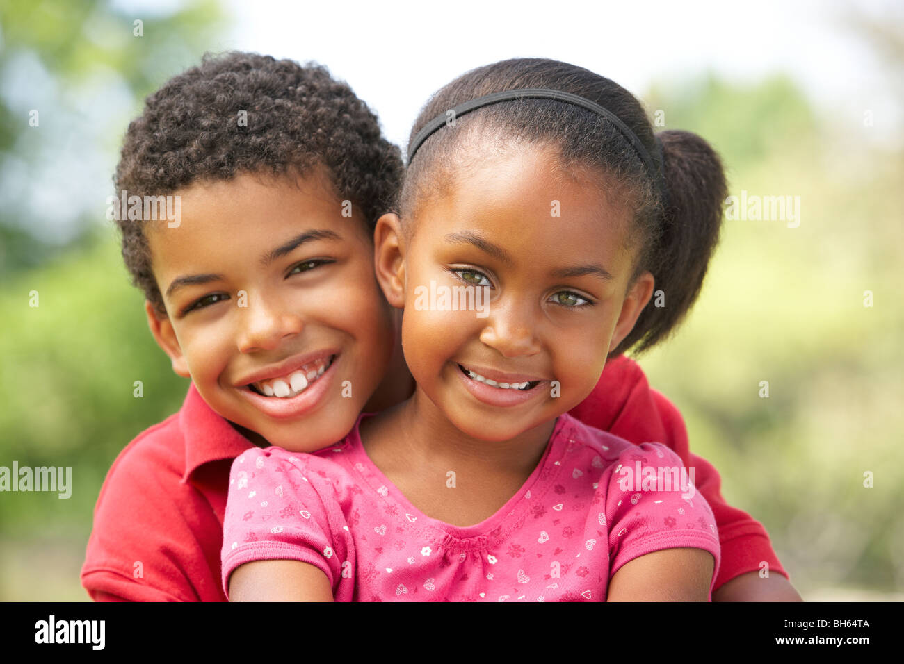 Portrait Of Brother And Sister In Park Stock Photo - Alamy