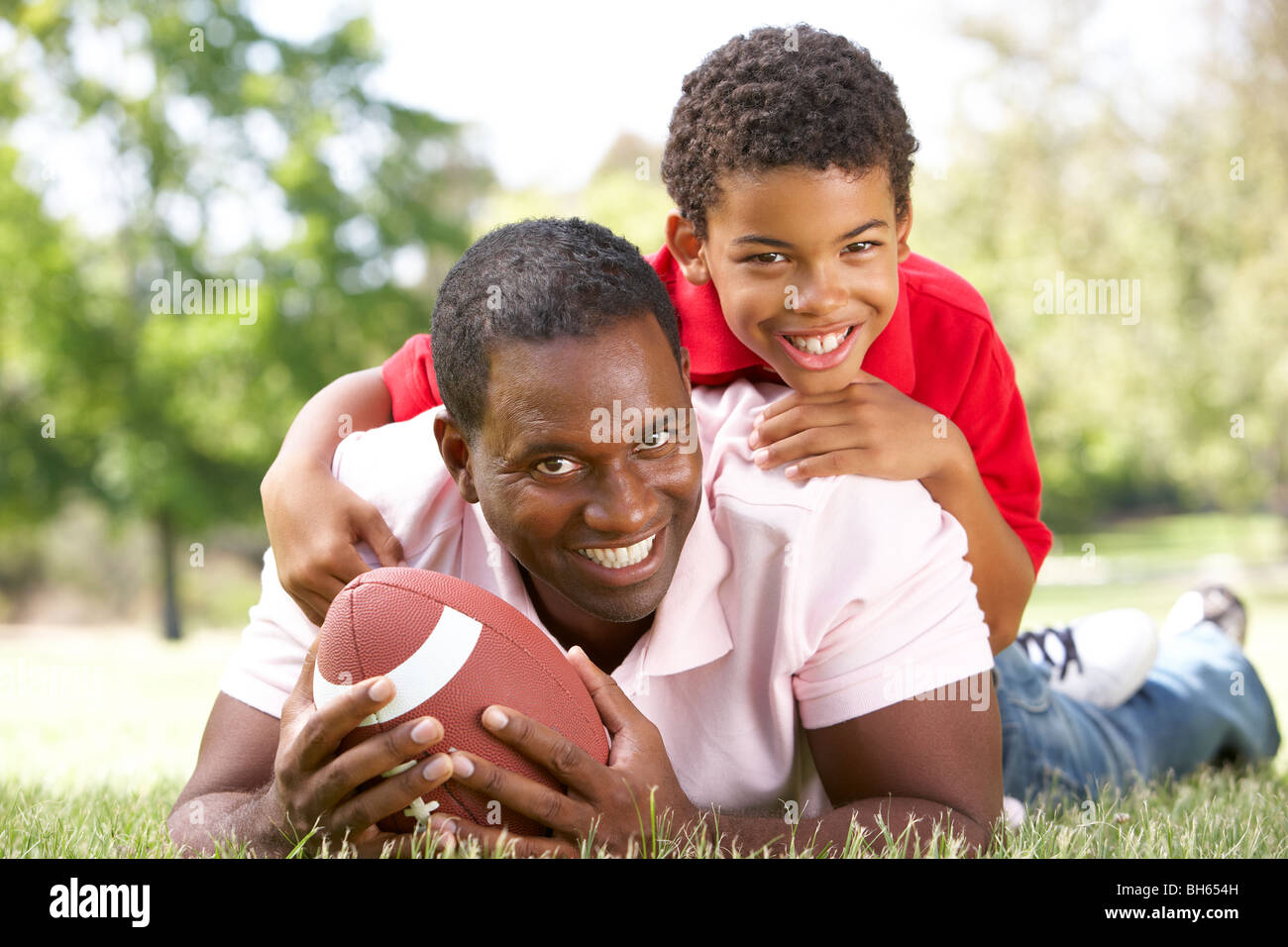 Father And Son In Park With American Football Stock Photo - Alamy