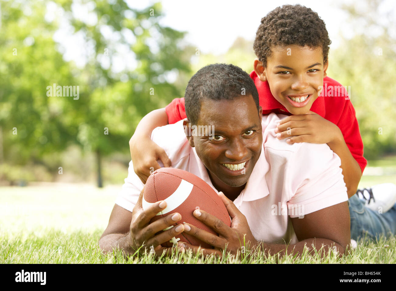 Father And Son In Park With American Football Stock Photo - Alamy