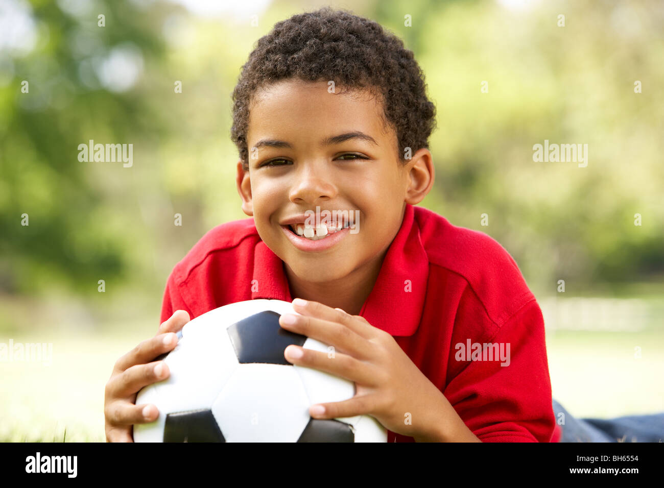 Boy In Park With Football Stock Photo