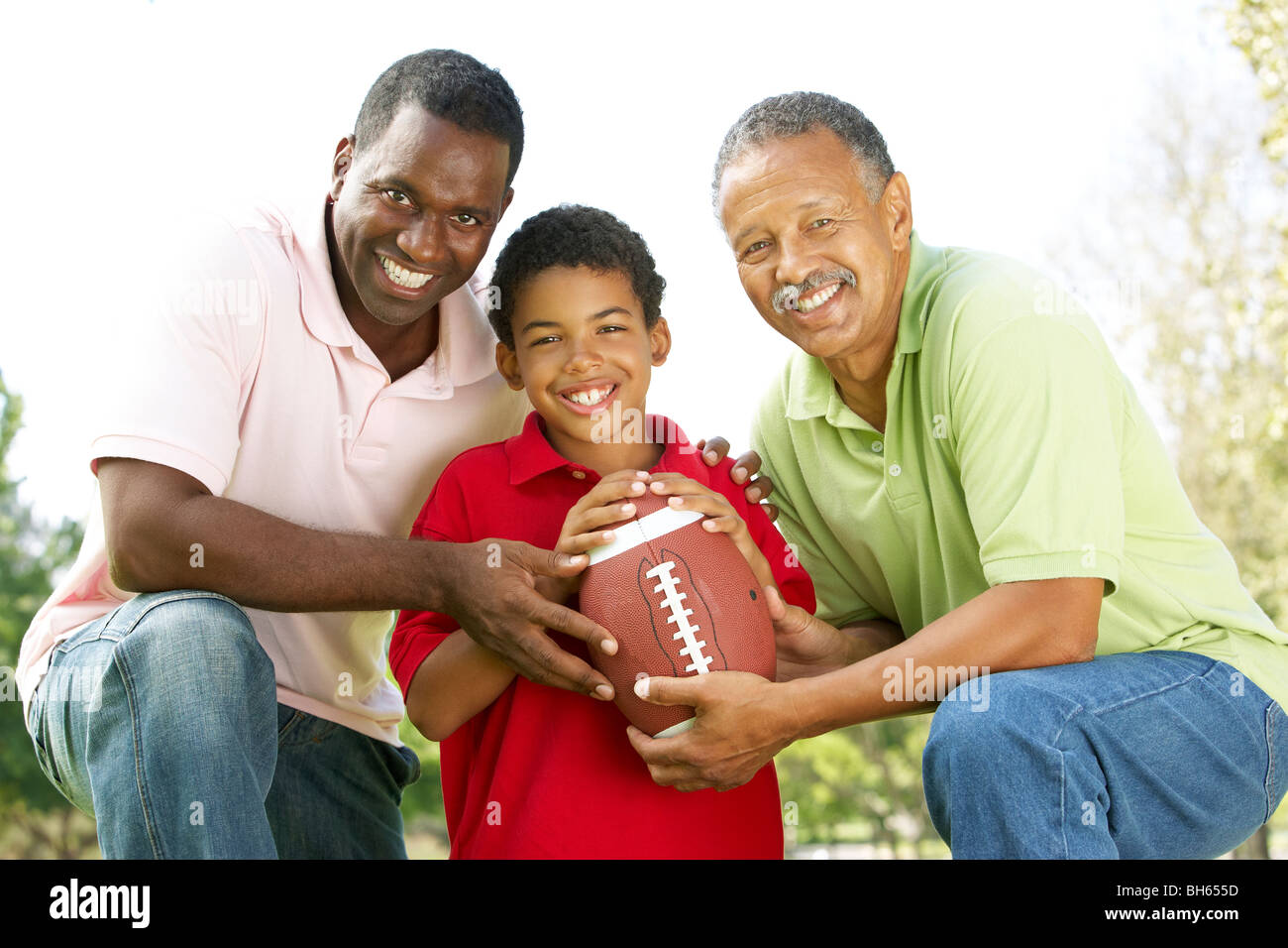 Grandfather With Son And Grandson In Park With American Football Stock Photo Alamy