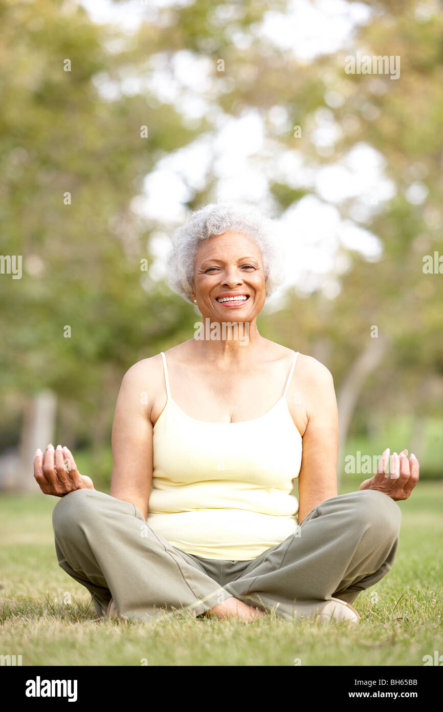 Senior Woman Doing Yoga In Park Stock Photo - Alamy