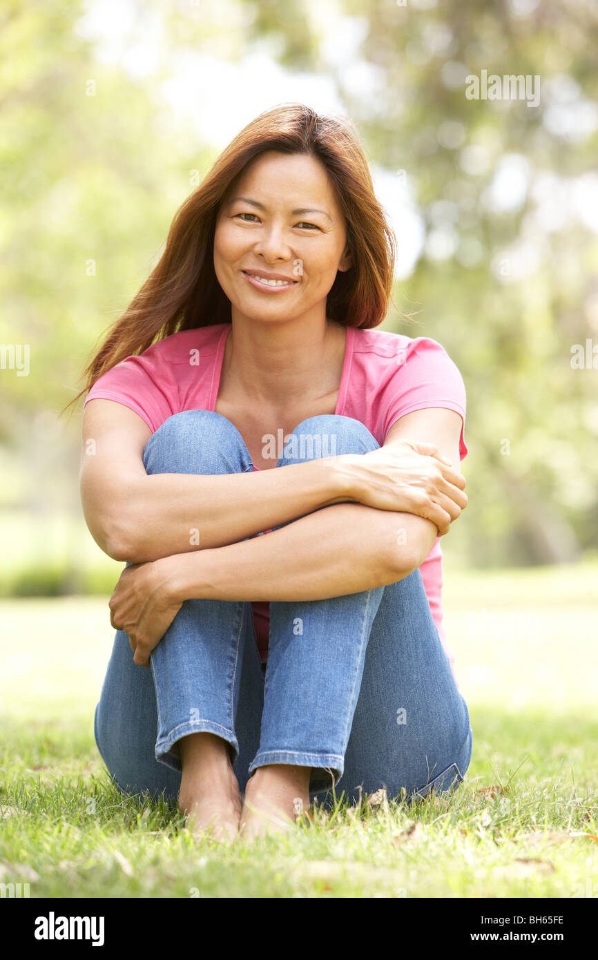 Portrait Of Young Woman In Park Stock Photo - Alamy