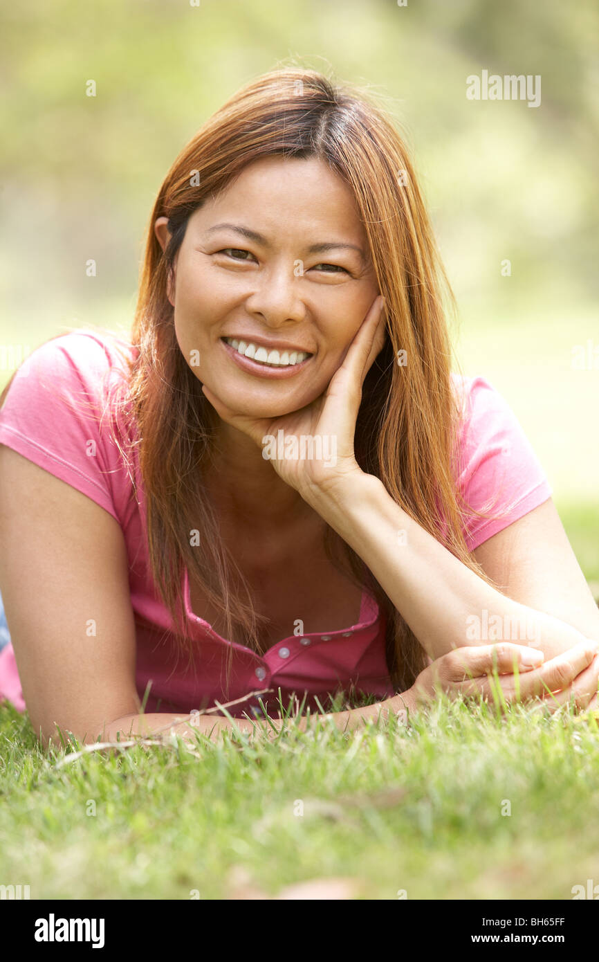 Portrait Of Young Woman In Park Stock Photo - Alamy