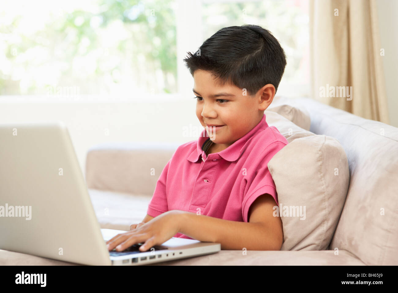 Young Boy Using Laptop At Home Stock Photo - Alamy