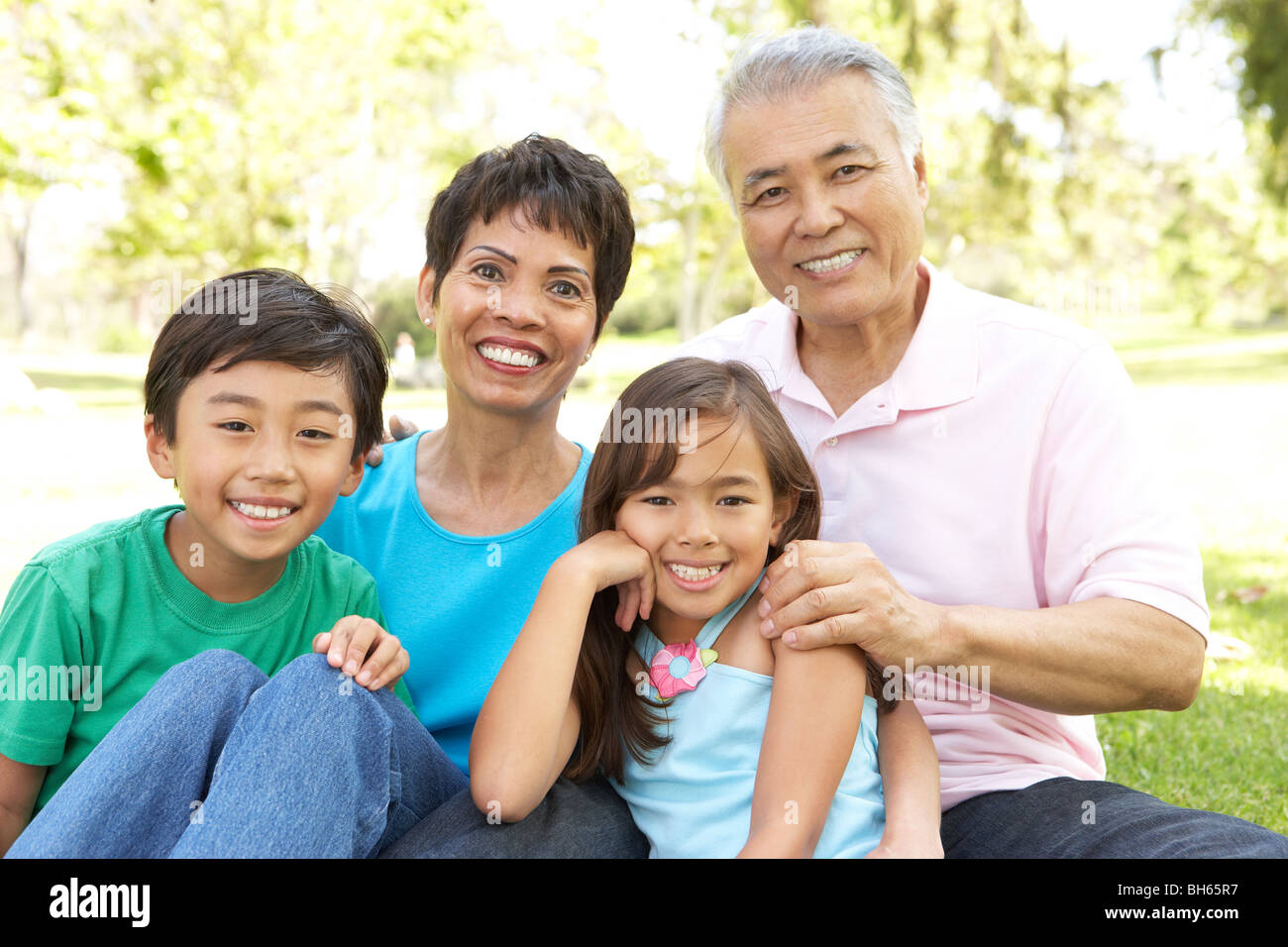 Portrait Of Grandparents With Grandchildren In Park Stock Photo