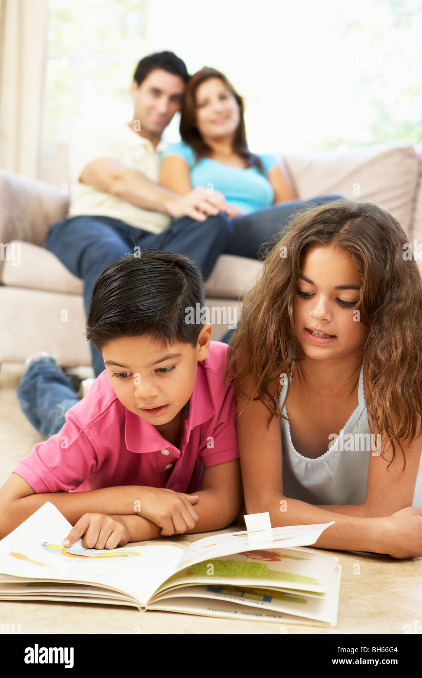 Children Reading Book At Home Stock Photo Alamy